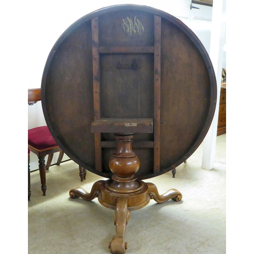 294 - An early Victorian mahogany breakfast table with a tip-top, over a turned column and splayed legs  2... 