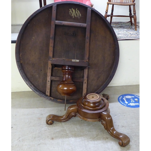 294 - An early Victorian mahogany breakfast table with a tip-top, over a turned column and splayed legs  2... 