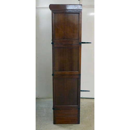 295 - A 1930s mahogany three section stacking bookcase with lift and slide doors, on a plinth incorporatin... 