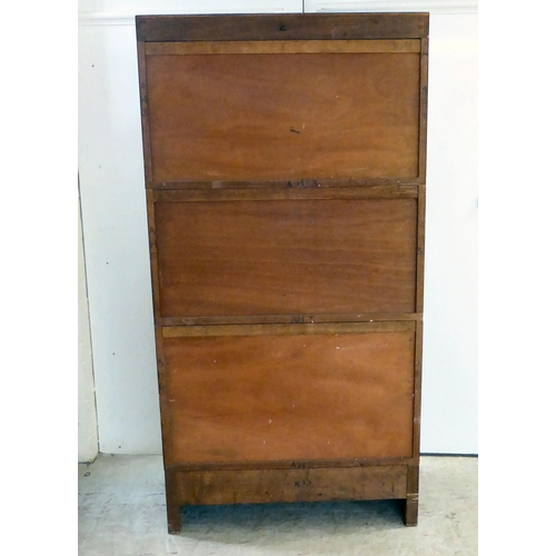 295 - A 1930s mahogany three section stacking bookcase with lift and slide doors, on a plinth incorporatin... 