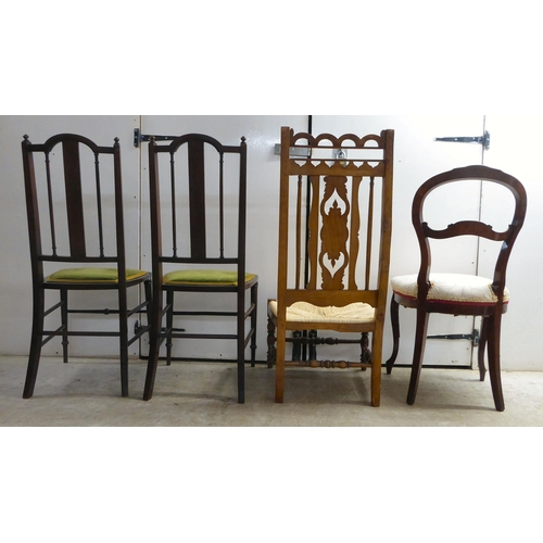 297 - Four dissimilar chairs: to include a pair of Edwardian mahogany framed, splat-back hall chairs, the ... 