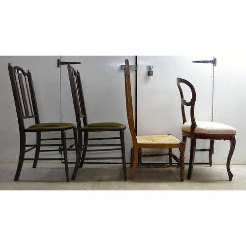 297 - Four dissimilar chairs: to include a pair of Edwardian mahogany framed, splat-back hall chairs, the ... 