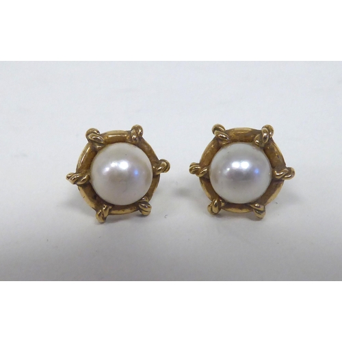 301 - A pair of 9ct gold, pearl set earrings