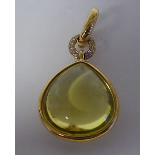 306 - An 18ct gold, lemon quartz set pendant, on a clip