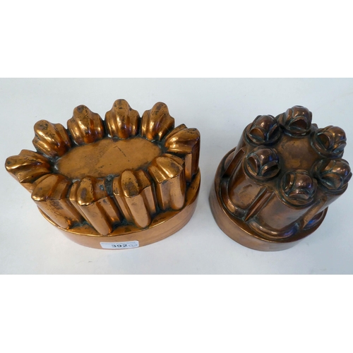 392 - A 19thC copper jelly mould of circular castellated design; and another similar of oval form