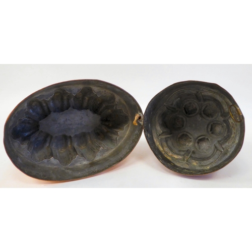 392 - A 19thC copper jelly mould of circular castellated design; and another similar of oval form