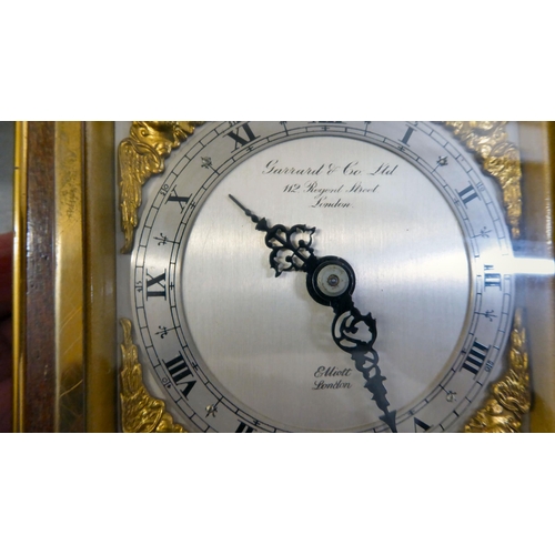 401 - An early 20thC brass and glazed mantel clock; the mercury weighted movement faced by an Arabic dial&... 