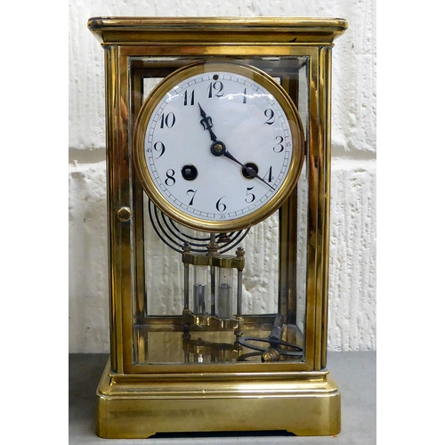 401 - An early 20thC brass and glazed mantel clock; the mercury weighted movement faced by an Arabic dial&... 