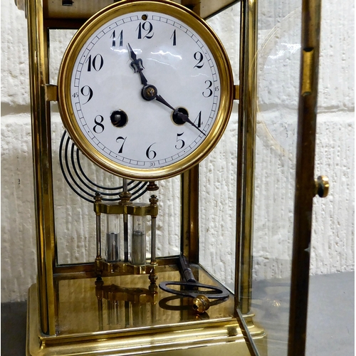 401 - An early 20thC brass and glazed mantel clock; the mercury weighted movement faced by an Arabic dial&... 