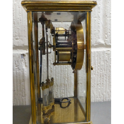 401 - An early 20thC brass and glazed mantel clock; the mercury weighted movement faced by an Arabic dial&... 