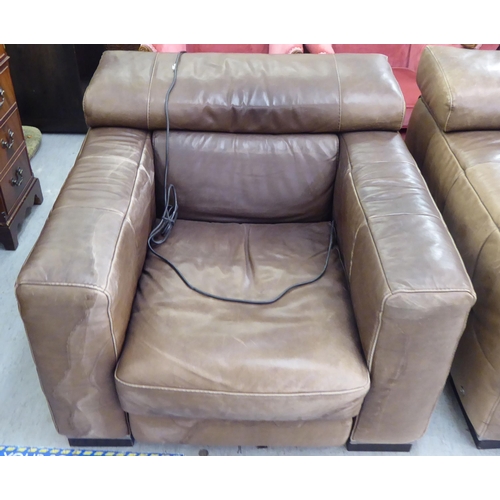 405 - A modern Natuzzi brown hide upholstered four section settee; and a matching chair