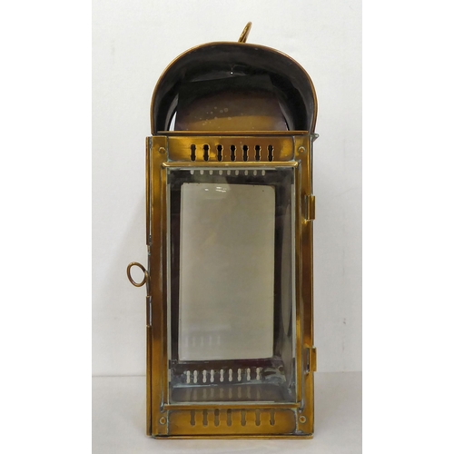 43 - A 19thC portable brass cased lantern with bevelled, clear glass panels, a folding top handle, bracke... 