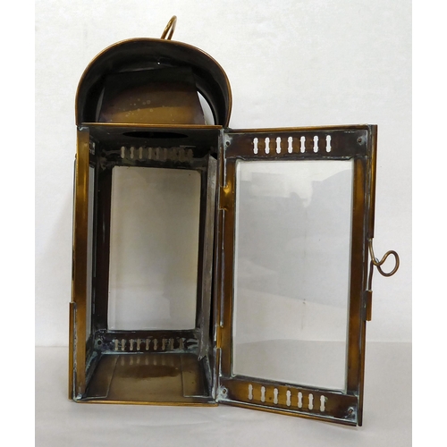 43 - A 19thC portable brass cased lantern with bevelled, clear glass panels, a folding top handle, bracke... 