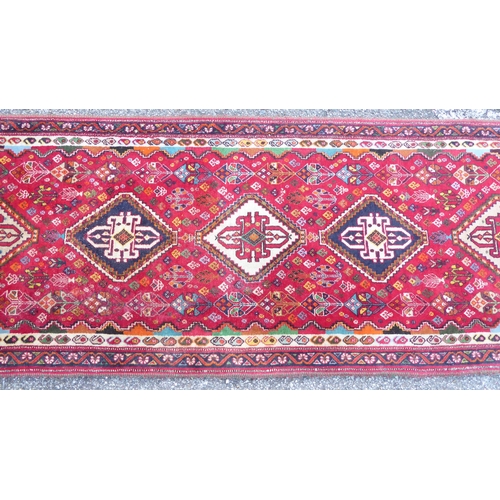 67 - A Persian style runner, decorated with central diamond formations, surrounded by stylised designs, o... 