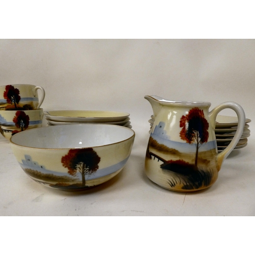 7 - A Japanese porcelain tea set, decorated with a landscape scene