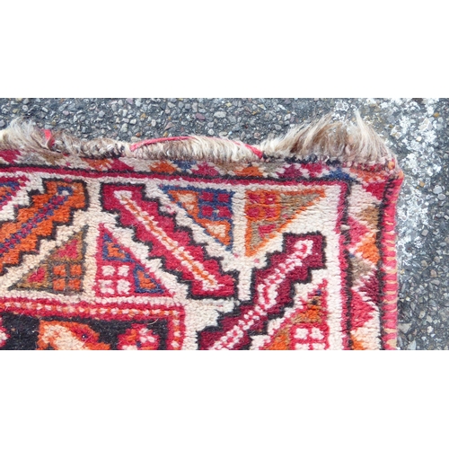 77 - A Ghashghai style Iranian rug, decorated with repeating stylised designs and zig-zag pattern border,... 