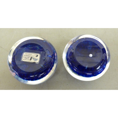 78 - Two millefiori glass paperweights, one bearing a label for Perthshire Paperweights, Crieff, Scotland... 