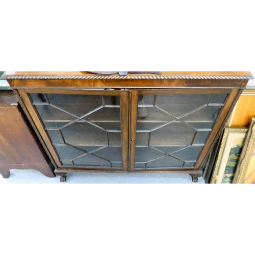 101 - A 1930s mahogany glazed bookcase with two shelves, raised on stubby cabriole legs  46