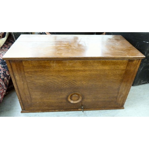 103 - An early 20thC oak chest with a rise-and-slide lockable front, enclosing a drawer interior  16