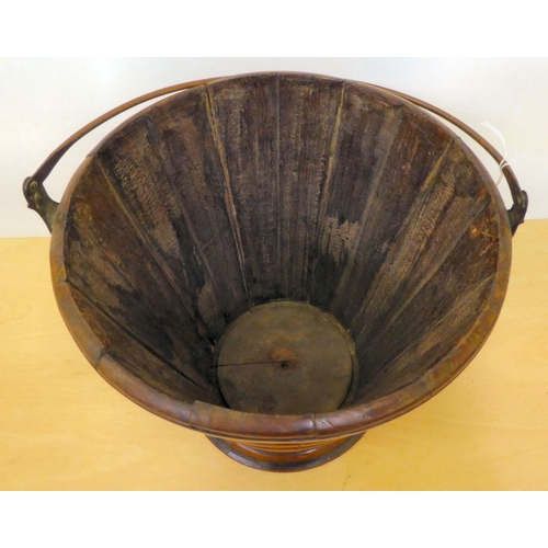 205 - A 19thC coopered wooden bucket of tapered, ribbed form with a brass collar and swing handle  12... 