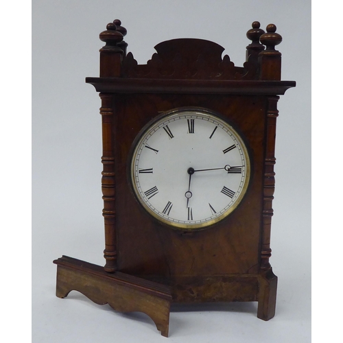 223 - A late 19thC walnut veneered cased mantel timepiece with turned, flank pilasters and a fretworked ga... 