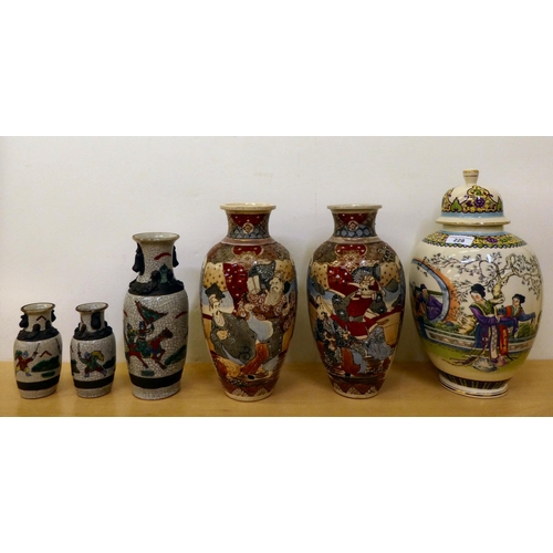 228 - 20thC Oriental ceramics: to include a pair of Japanese crackle glazed vases, decorated with warriors... 