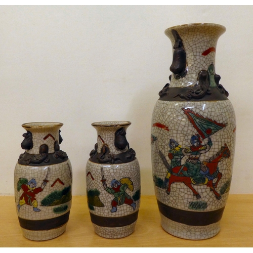 228 - 20thC Oriental ceramics: to include a pair of Japanese crackle glazed vases, decorated with warriors... 