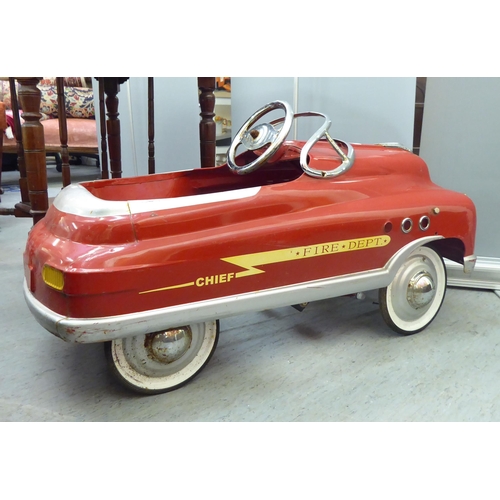 232 - A mid 20thC tinplate pedal car, in red livery, fashioned as a Fire Department Chief vehicle  36