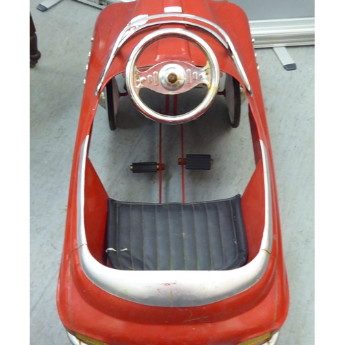 232 - A mid 20thC tinplate pedal car, in red livery, fashioned as a Fire Department Chief vehicle  36