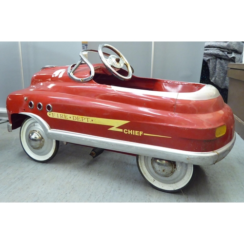 232 - A mid 20thC tinplate pedal car, in red livery, fashioned as a Fire Department Chief vehicle  36