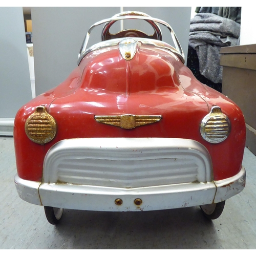 232 - A mid 20thC tinplate pedal car, in red livery, fashioned as a Fire Department Chief vehicle  36