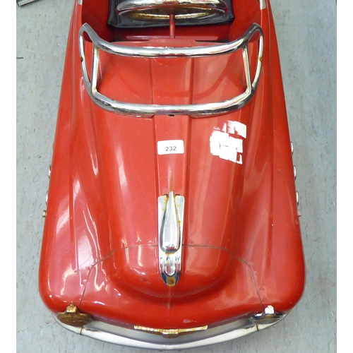 232 - A mid 20thC tinplate pedal car, in red livery, fashioned as a Fire Department Chief vehicle  36