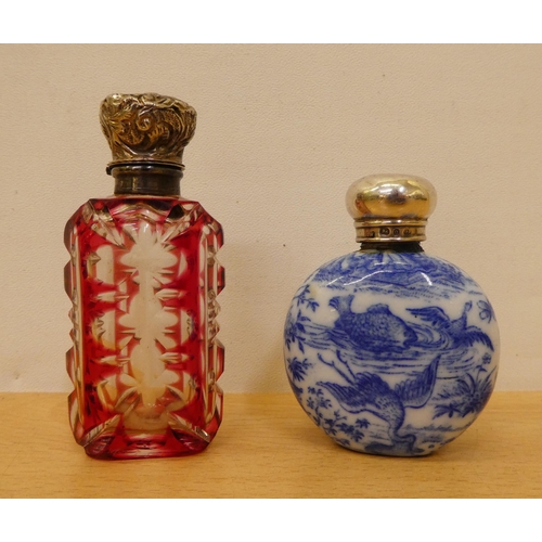 402 - Two silver capped scent bottles, viz. a cranberry glass example  2.75