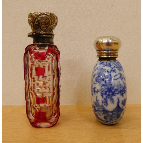 402 - Two silver capped scent bottles, viz. a cranberry glass example  2.75