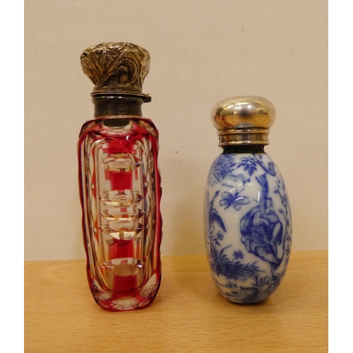 402 - Two silver capped scent bottles, viz. a cranberry glass example  2.75