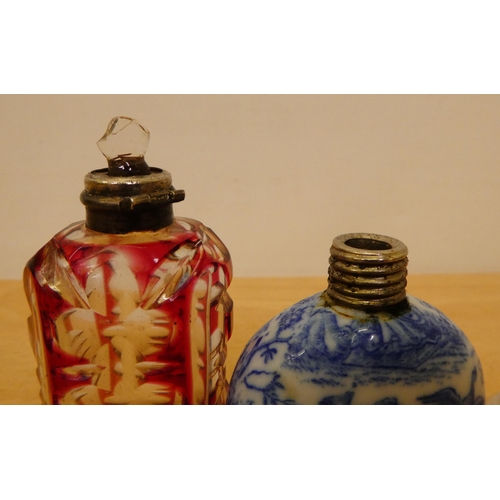 402 - Two silver capped scent bottles, viz. a cranberry glass example  2.75