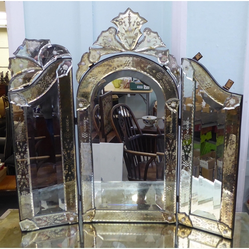 83 - A modern Venetian style partially mirrored dressing table with a central drawer, raised on square, t... 