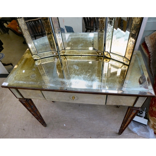 83 - A modern Venetian style partially mirrored dressing table with a central drawer, raised on square, t... 