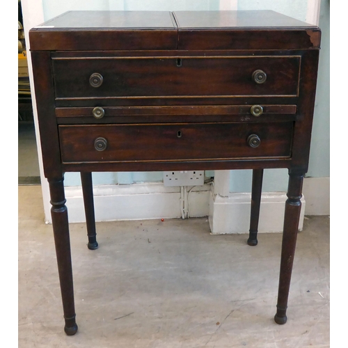 87 - A George III mahogany vanity unit with a pair of hinged flaps, revealing a mirror, over a brushing s... 