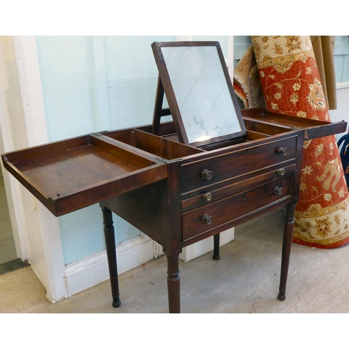 87 - A George III mahogany vanity unit with a pair of hinged flaps, revealing a mirror, over a brushing s... 