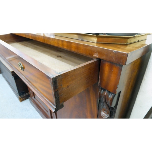 89 - A mid Victorian mahogany chiffonier with a pair of panelled doors, on a plinth  35