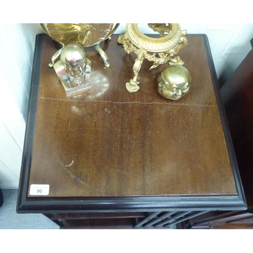 90 - An early 20thC mahogany two tier, open front revolving bookcase, on a splayed plinth and casters&nbs... 