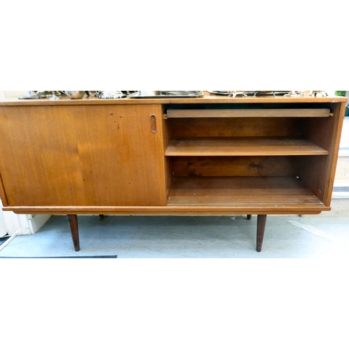 92 - A 1970s teak sideboard with a pair of sliding doors, raised on turned, tapered legs  29