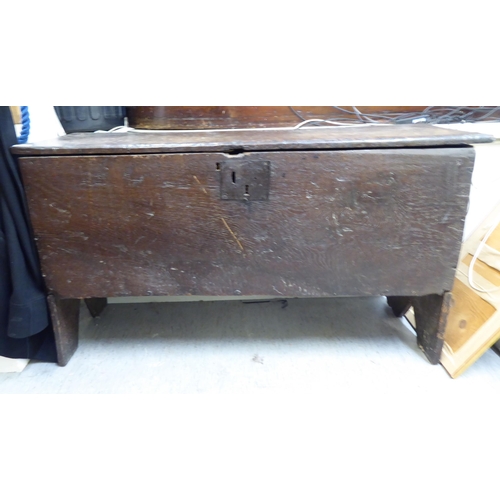 98 - An 18thC country made boarded oak coffer with straight sides and a hinged lid  25