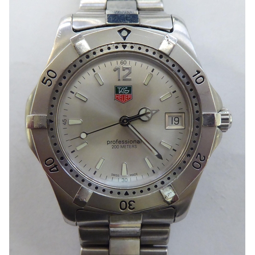 200 - A Tag Heuer stainless steel cased bracelet wristwatch, faced by a baton dial, incorporating a date a... 