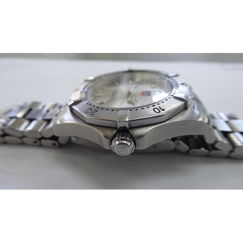 200 - A Tag Heuer stainless steel cased bracelet wristwatch, faced by a baton dial, incorporating a date a... 