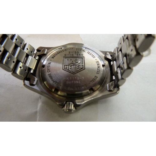 200 - A Tag Heuer stainless steel cased bracelet wristwatch, faced by a baton dial, incorporating a date a... 