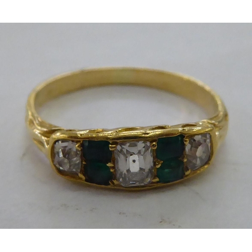 211 - An 18ct gold emerald and diamond set ring