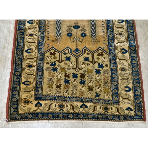 11 - A Turkish prayer rug, on a multi-coloured ground  45