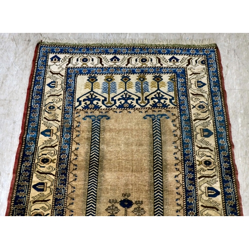 11 - A Turkish prayer rug, on a multi-coloured ground  45